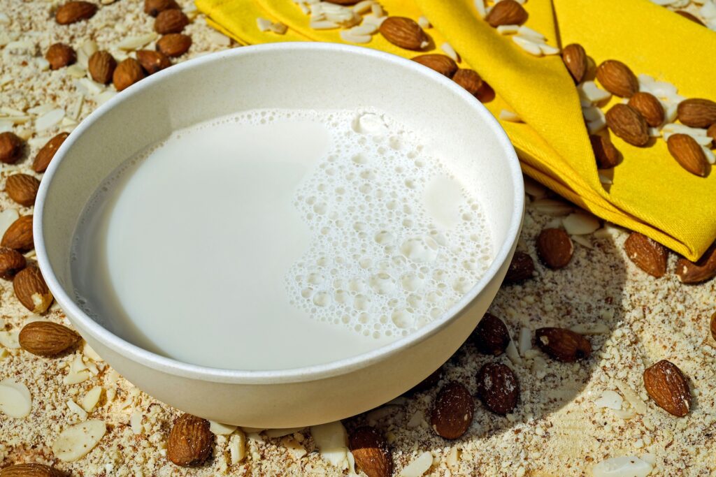bowl of almond milk with almonds around it
