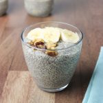 Glass with chia pudding and banana slices and walnuts.