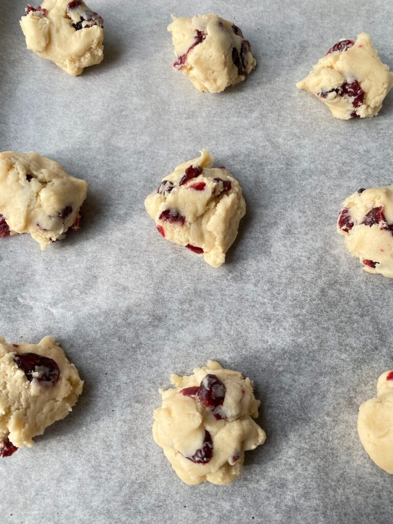 cranberry almond cookie dough on baking sheet
