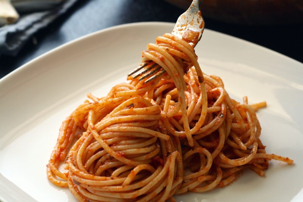 fork with spaghetti and tomato sauce