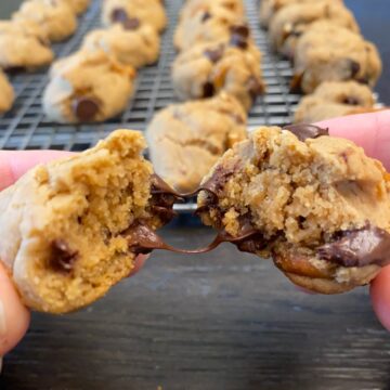 trail mix cookie in half with melty chocolate