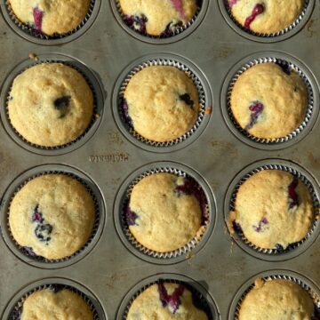 muffin pan with cooked lemon blueberry muffins