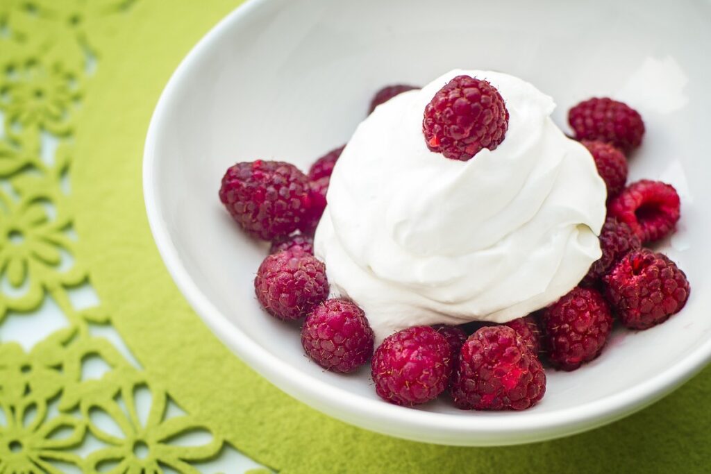 bowl with cream and raspberries