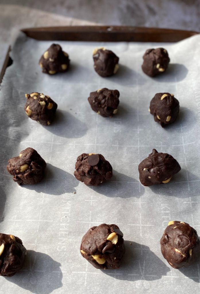 chocolate cookie balls on a baking sheet