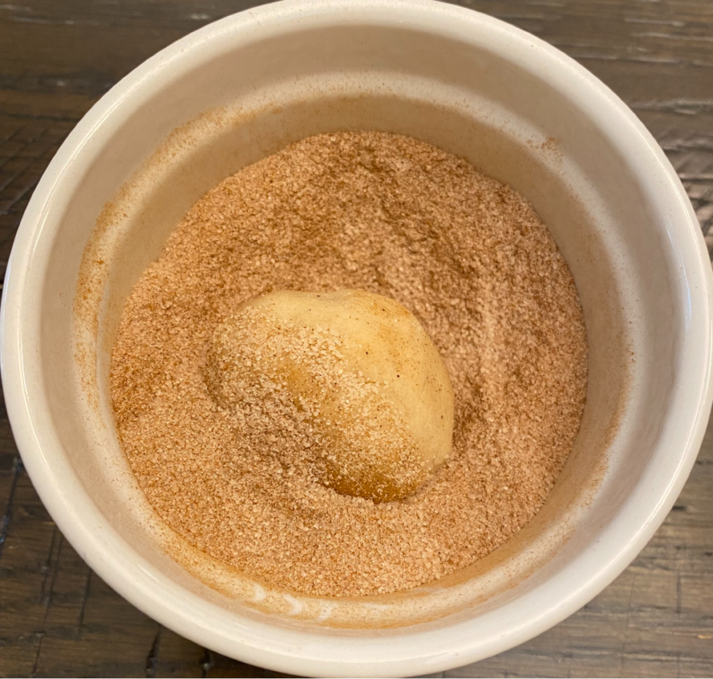 dough ball in cinnamon sugar mixture