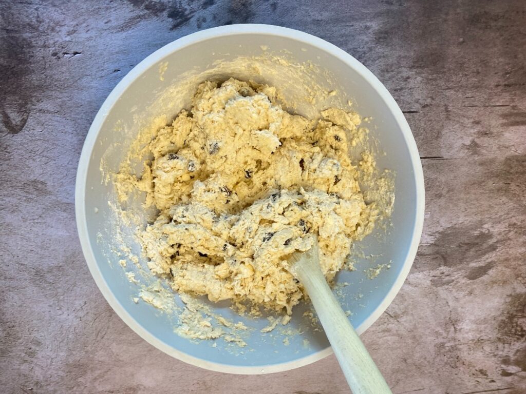 soda bread dough in bowl with wooden spoon