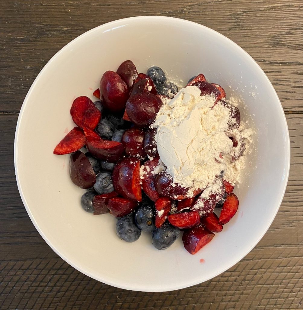 bowl with cherries, blueberries and flour