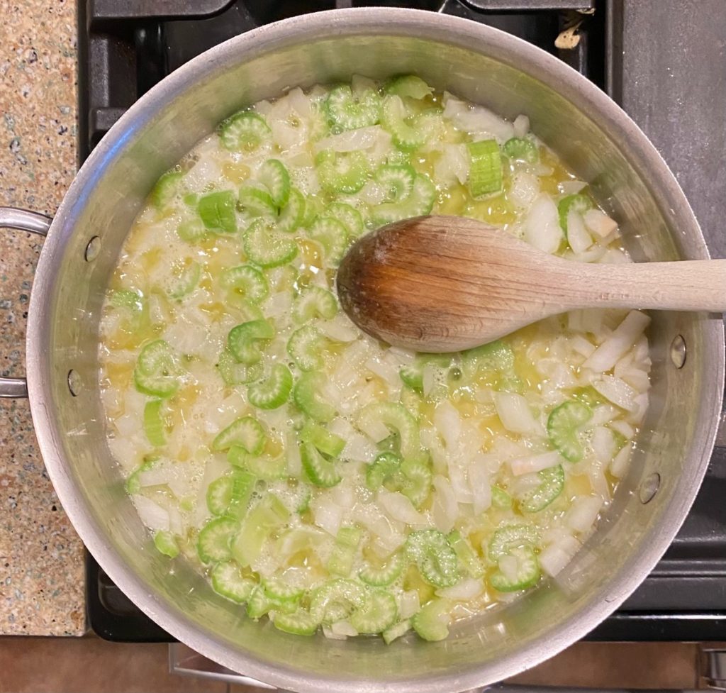pan with celery and onions in vegan butter.