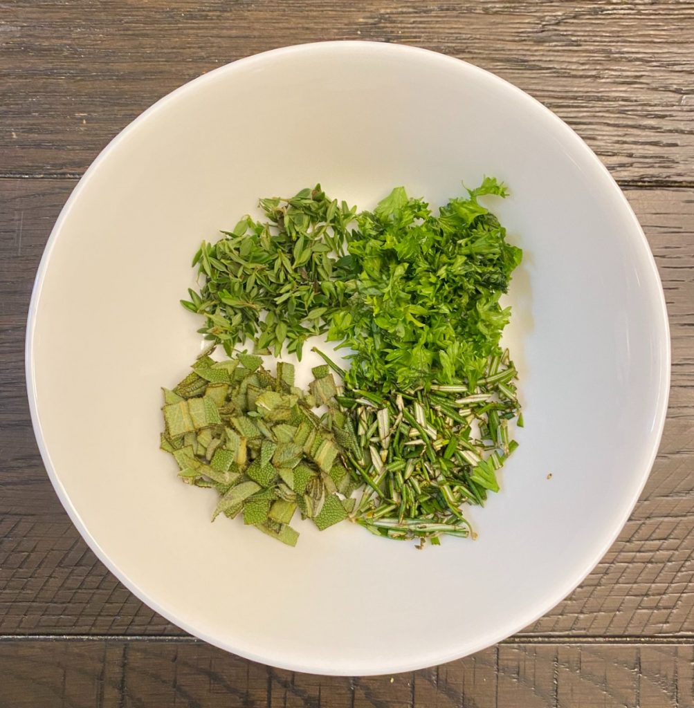 small bowl with parsley, sage, rosemary and thyme.