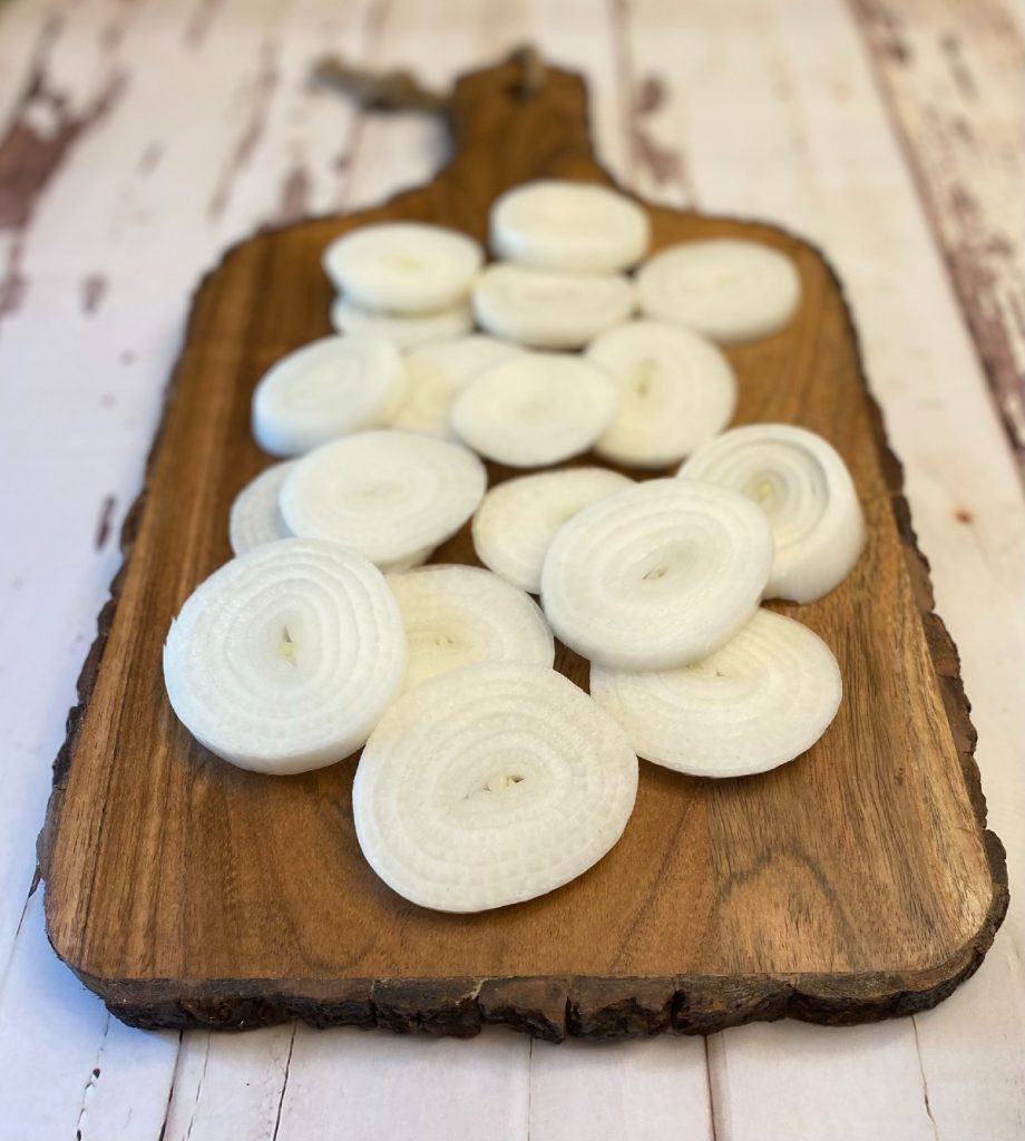 cutting board with sliced onions