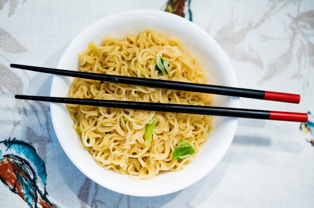 ramen in a bowl with chopsticks on top.