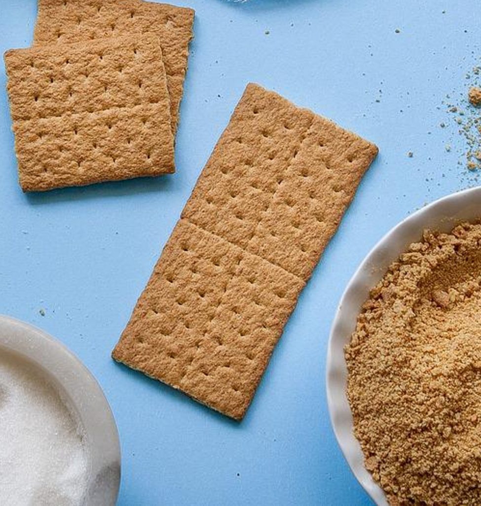 graham crackers with bowls of sugar and graham crumbs.