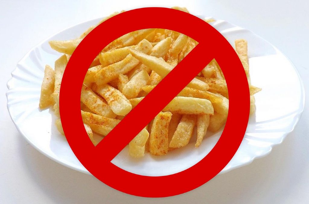 the "no" symbol over a plate of french fries.