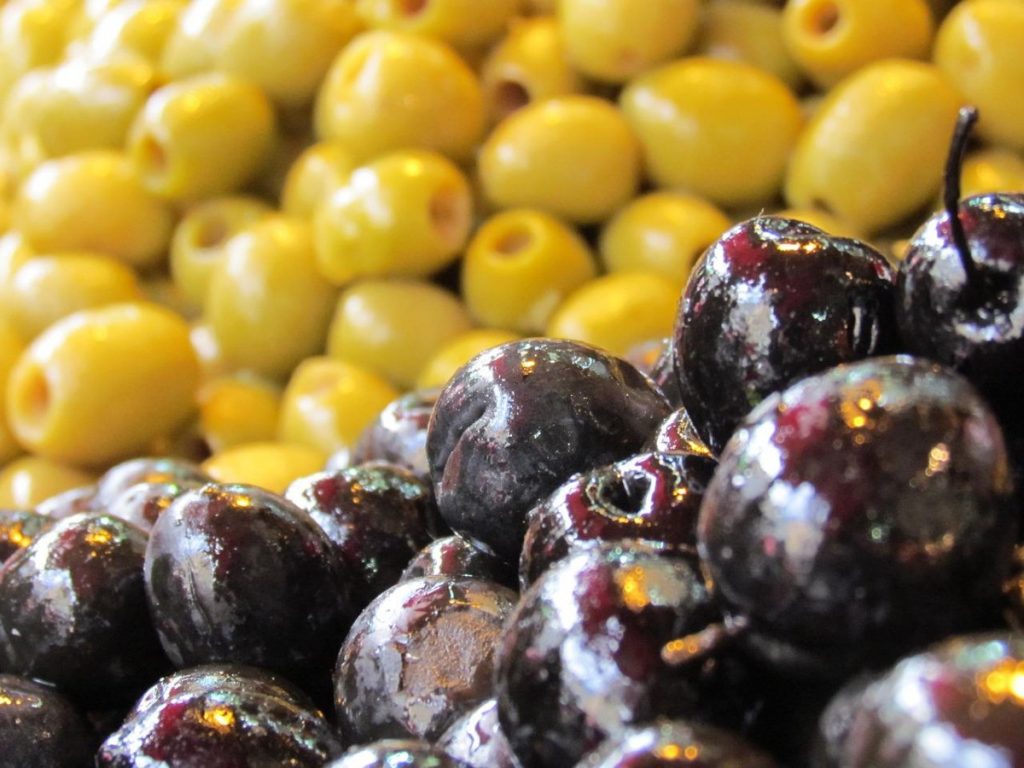 close up of black and green olives.