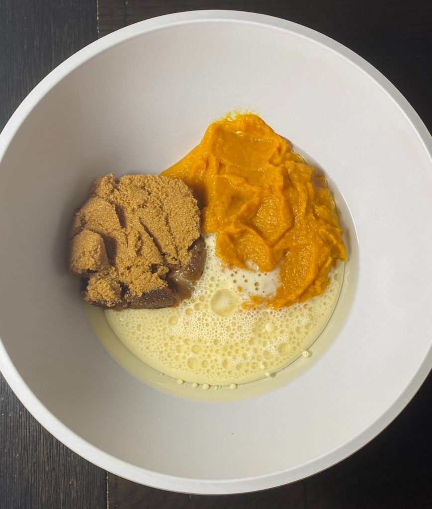 brown sugar, pumpkin, oil and milk in a bowl.