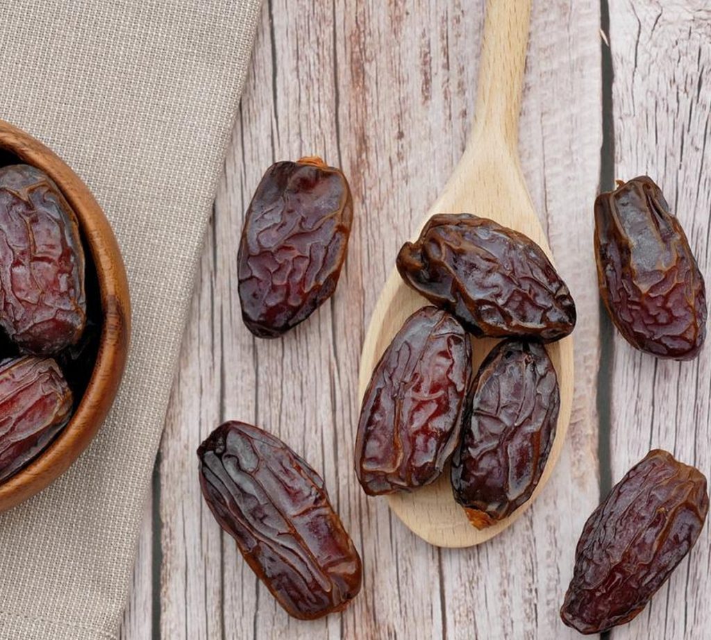 dates on a wooden spoon.