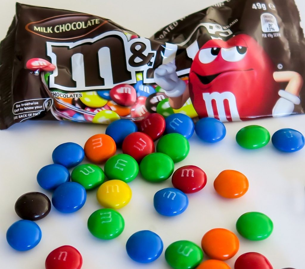 bag of m&ms with some spilled out.