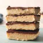 Chocolate coconut bars stacked.