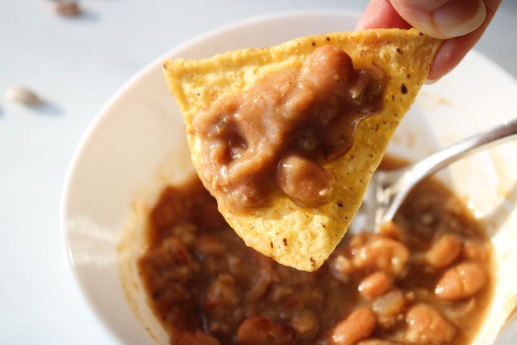 Pinto beans on a tortilla chip.