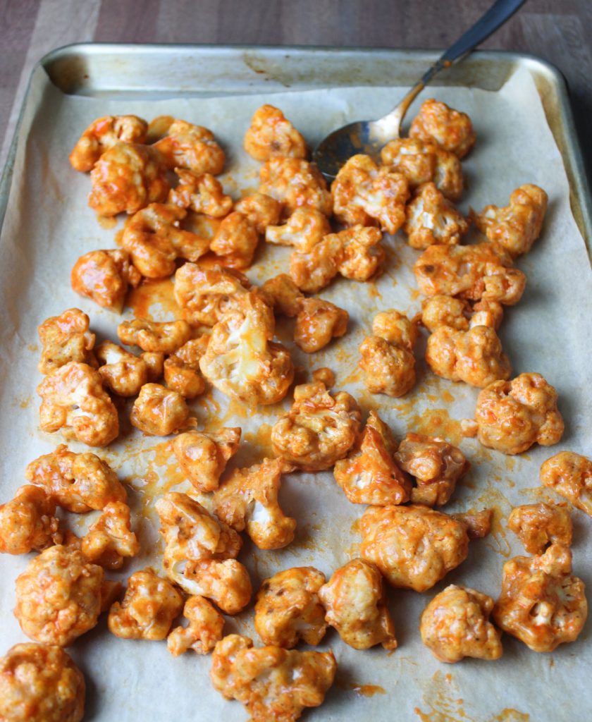 Cauliflower pieces covered in buffalo sauce.
