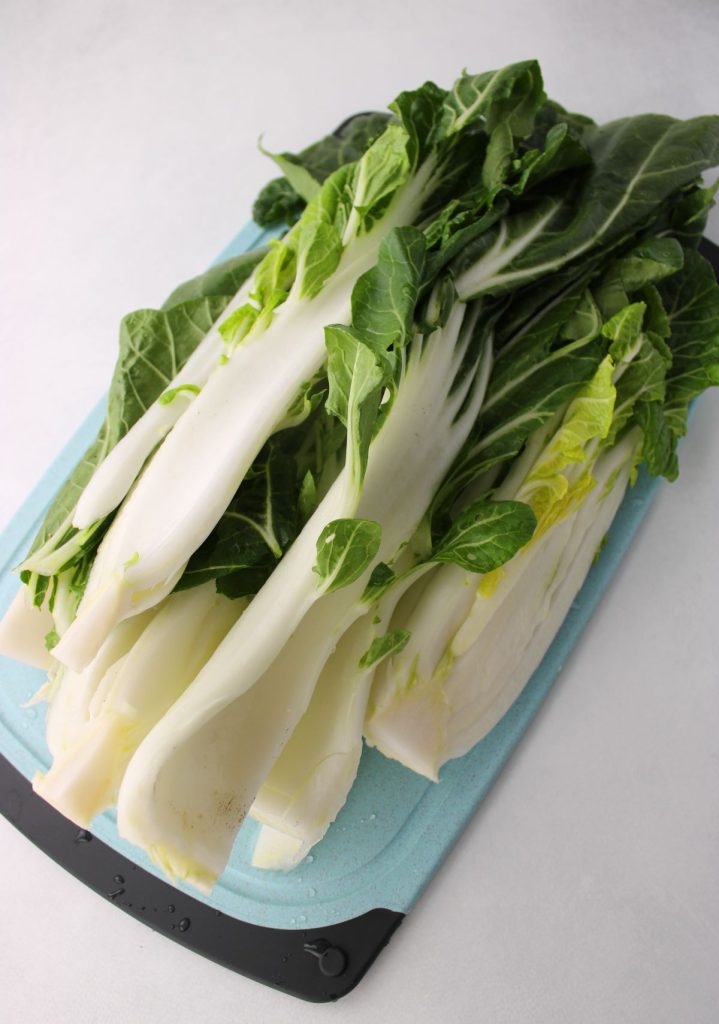 Bok choy trimmed and on cutting board.