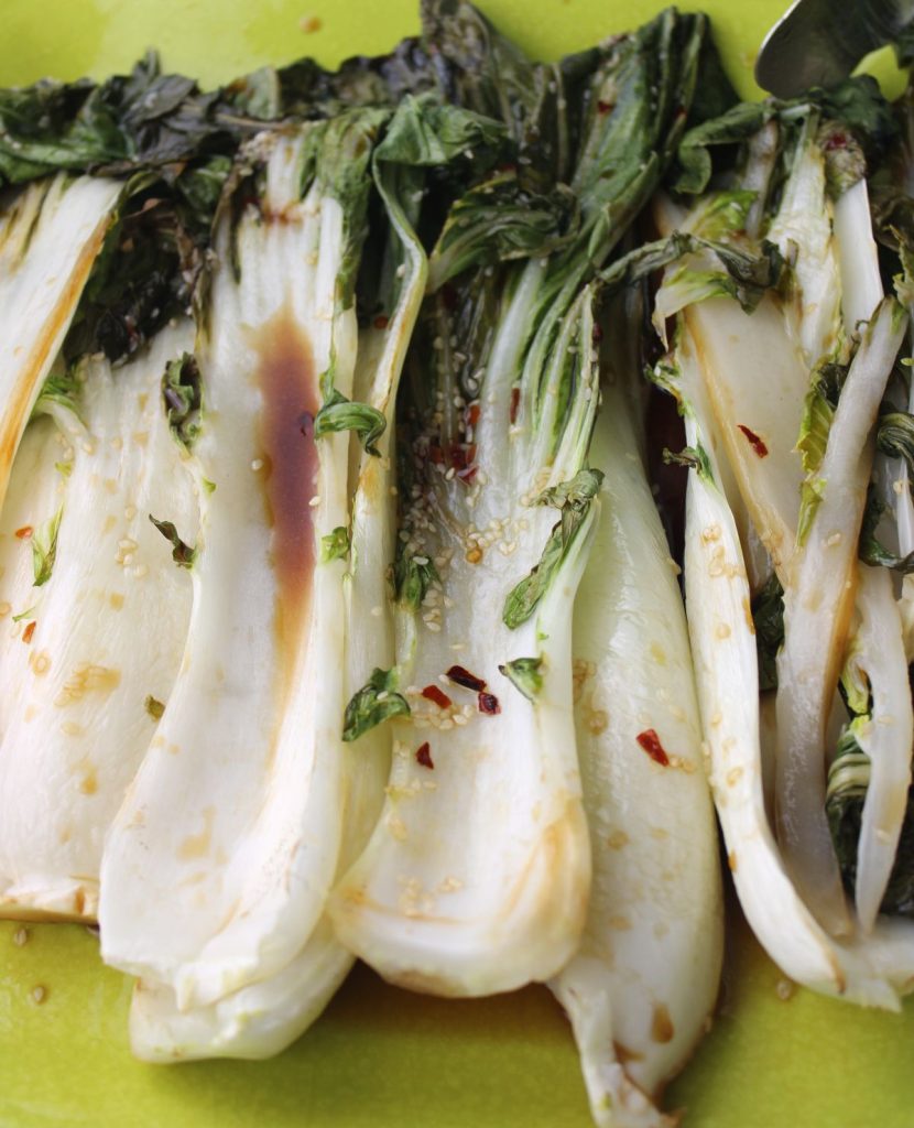 Close up of roasted bok choy on a platter.