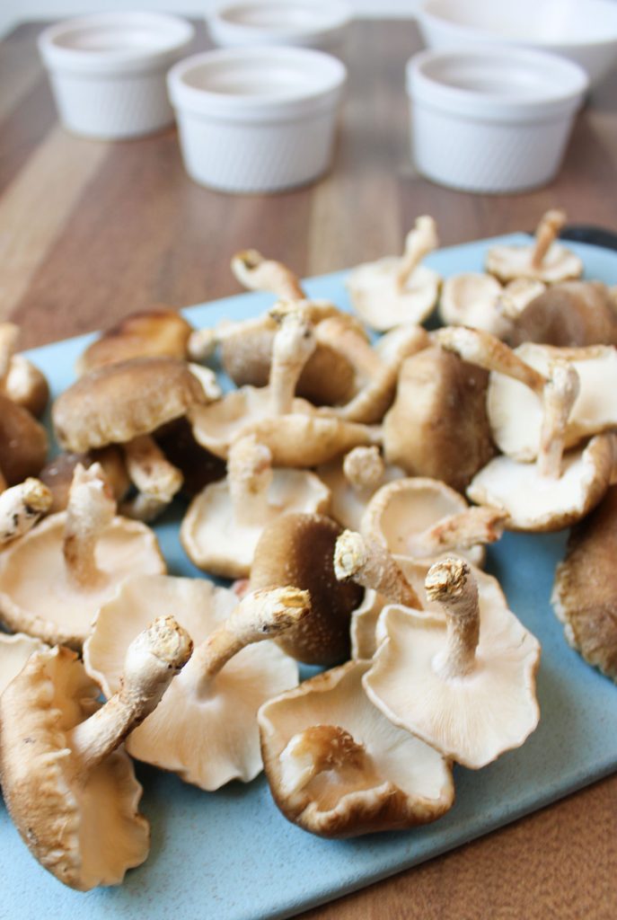 Shiitake mushrooms on a cutting board.