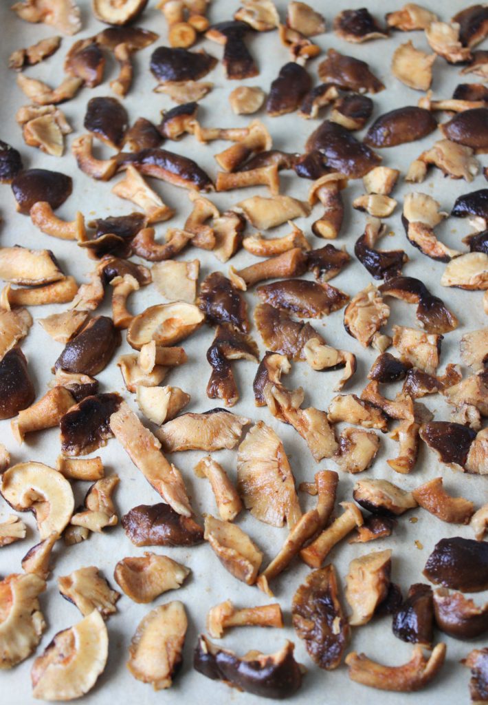 Mushroom pieces on baking sheet.