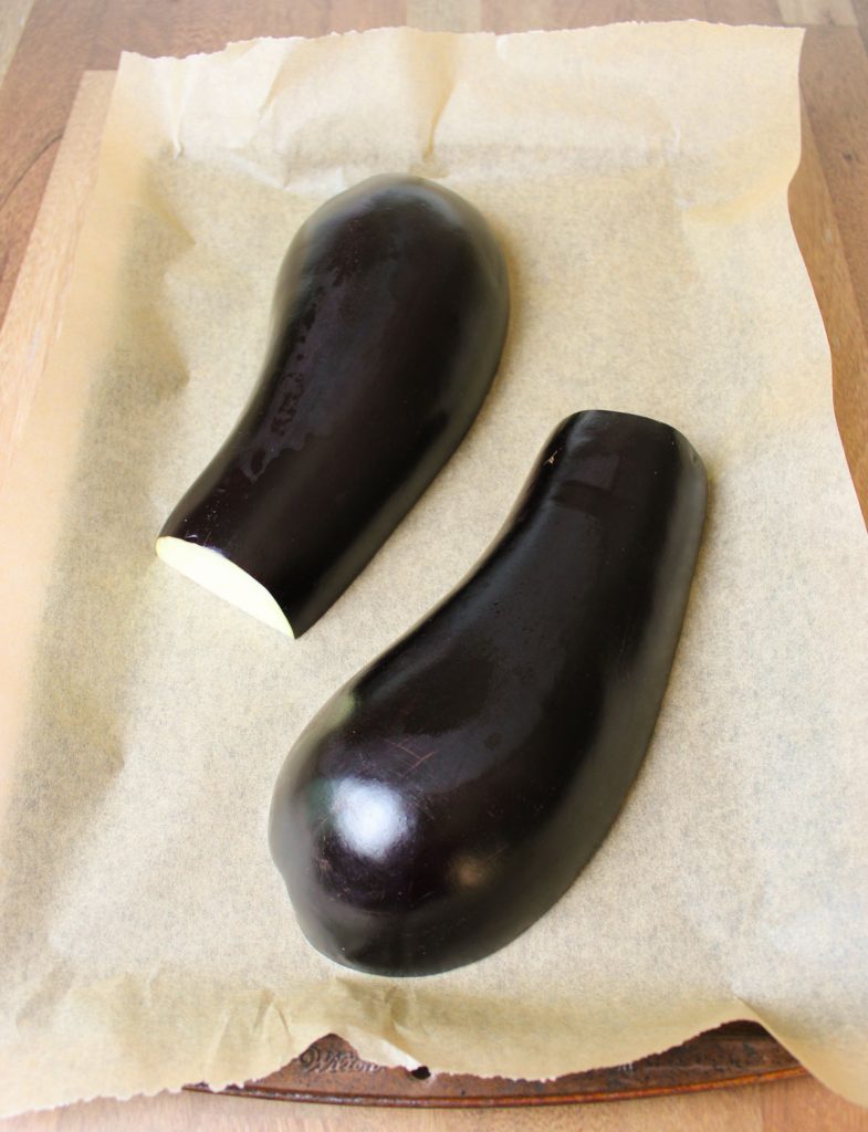 Eggplant halves on baking sheet.