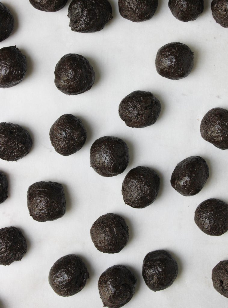 Truffle balls on a cookie sheet.