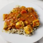 Plate of tofu curry with rice.