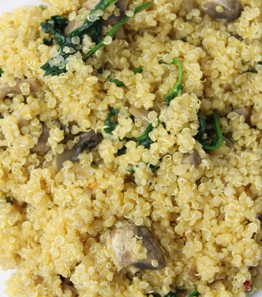 Closeup of quinoa with spinach and mushrooms.
