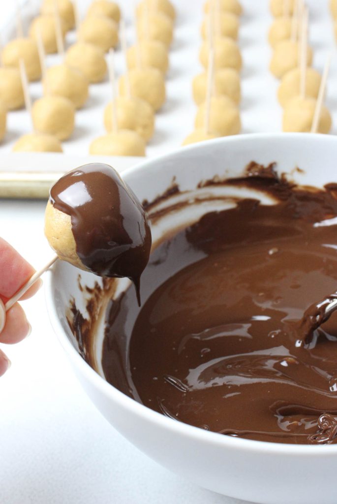 Buckeye being dipped in chocolate.